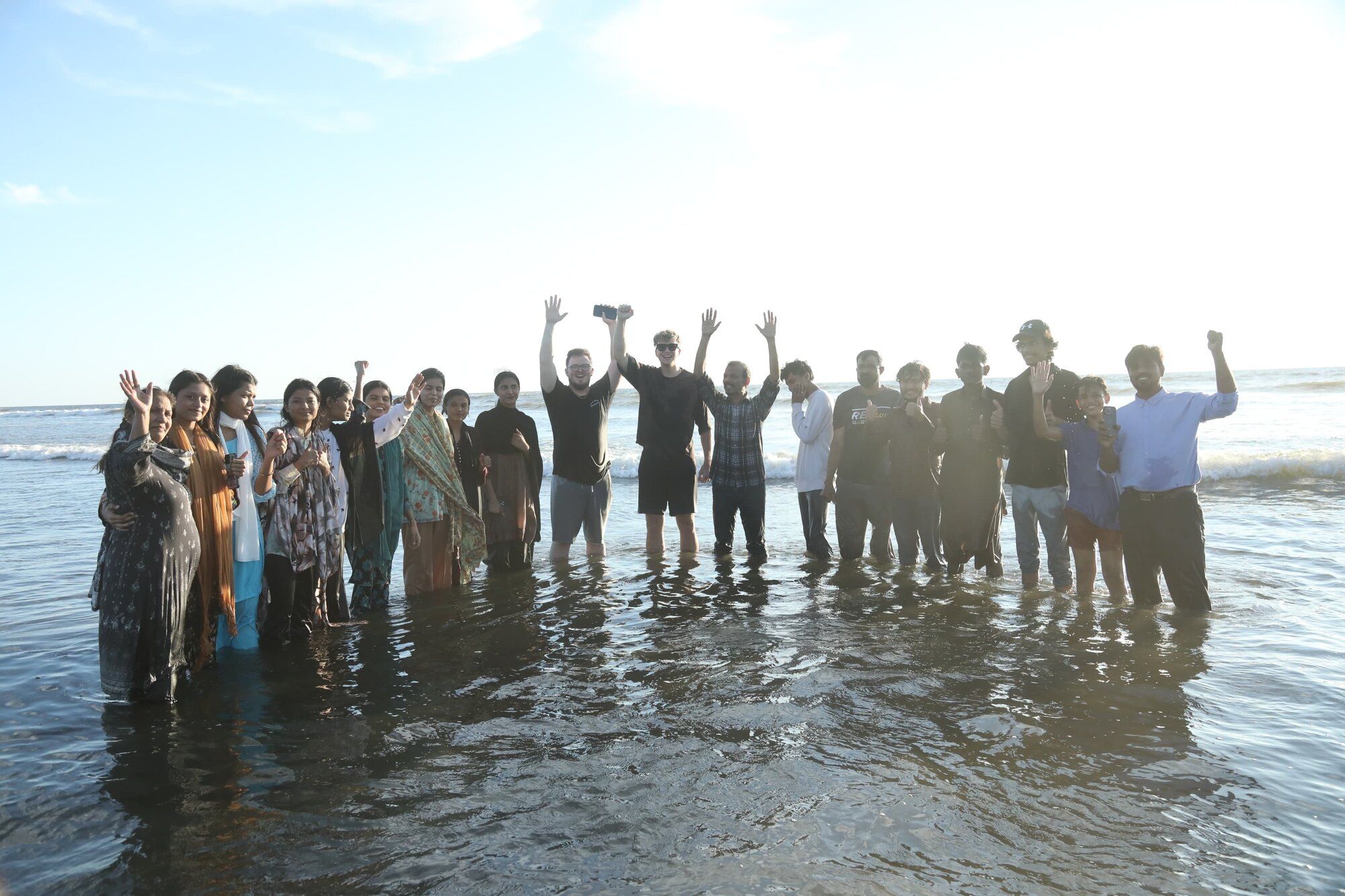 A group celebrating baptisms in the ocean