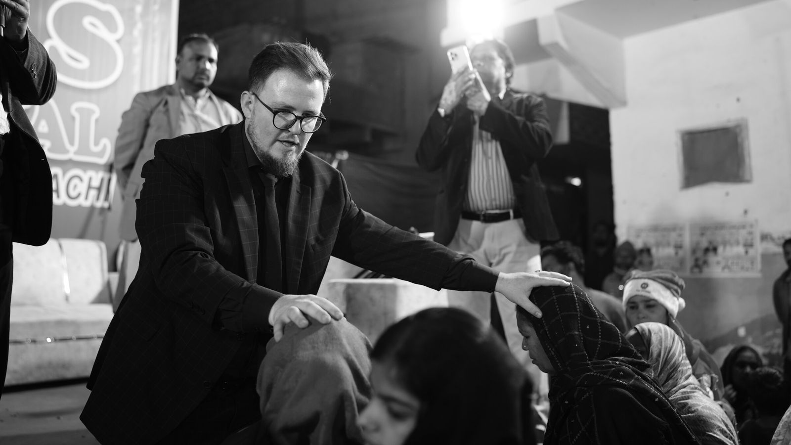 Laying hands on people in prayer at a crusade in Pakistan