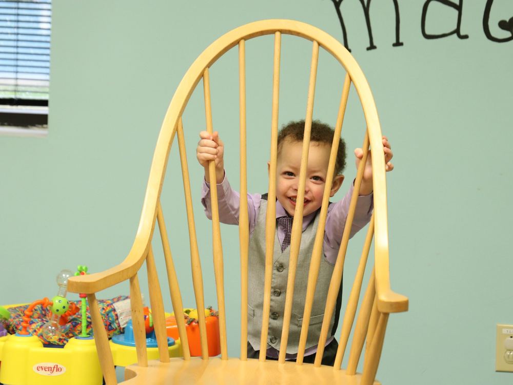 A toddler smiling in the nursery