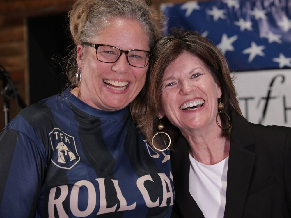 Two women laughing together at The Father's House